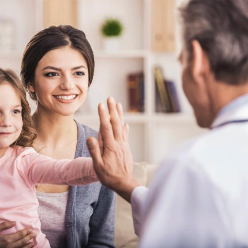 Girl and Doc Doing High Five. Smiling Little Girl. Doctor Calms of Small Patient. Family on Consulation of Pediatrician. Healthcare Concept. Happy Cute Baby. Professional Home Visit.